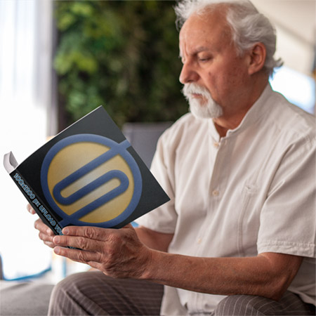 About Sunbelt Business Brokers information brochure being read by a man.